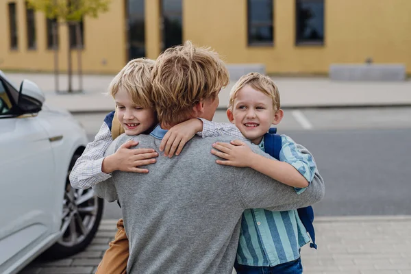 Father Saying Goodbyeto Sons Front School Building Hugging Both Boys — Stock Photo, Image