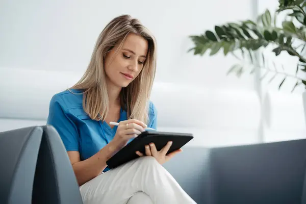 Portrait Female Doctor Sitting Office Looking Test Results Scans Tablet — Stock Photo, Image