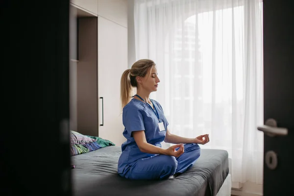 Female Nurse Doctor Enjoying Free Time Home Work Meditating Bedroom — Stock Photo, Image