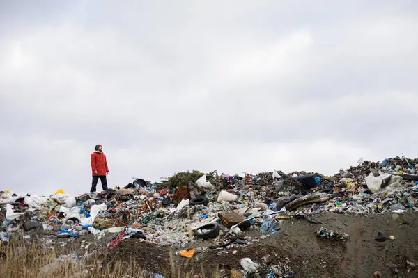 Activist Red Jacket Standing Landfill Large Pile Waste Dark Clouds — Stock Photo, Image