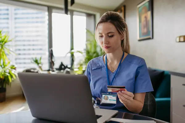 Nurse Paying Bills Online Debit Credit Card Working Notebook Doctor — Stock Photo, Image