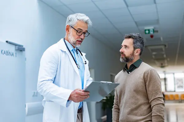 Doctor Talking Patient Hospital Corridor Handsome Doctor Gray Hair Holding — Stock Photo, Image