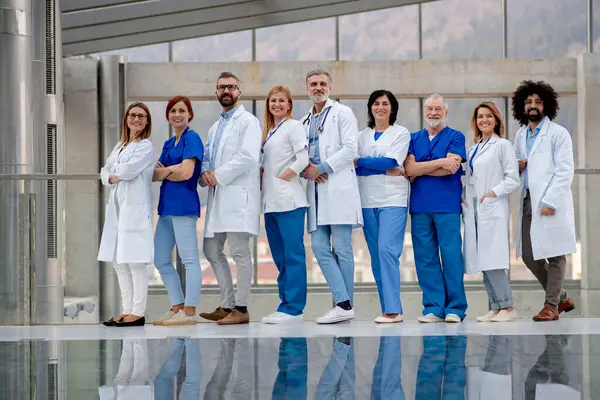 医生团队的肖像 全长与反思 由医生 穿着医院制服的专业人员 现代诊所组成的保健小组 — 图库照片