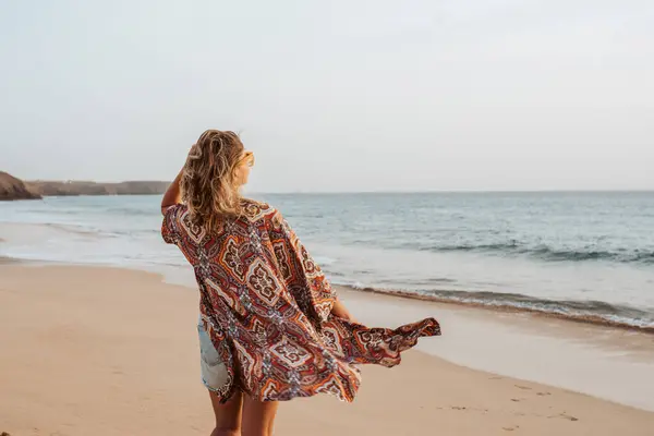 砂浜に立っている美しいスリムな女性のリアビュー 海を見ている裸足の女性の全身ショット ビーチ夏休みのコンセプト ロイヤリティフリーのストック画像