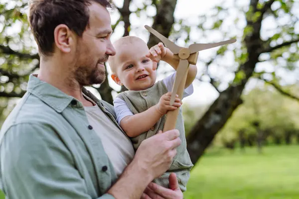 Baby Father Holding Wind Turbine Model Outdoors Park Concept Renewable — Stock Photo, Image