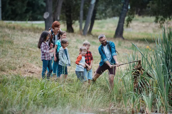 Teacher Showing Decaying Water Lake Plants School Children Field Teaching Стокова Картинка