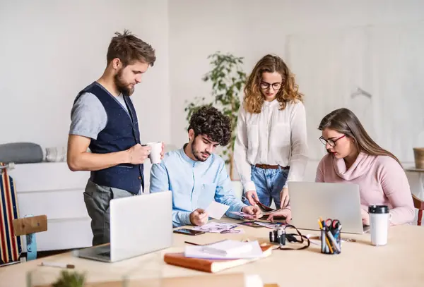 stock image Young group of colleagues working on new project together in a startup company office. Working in co-working space.