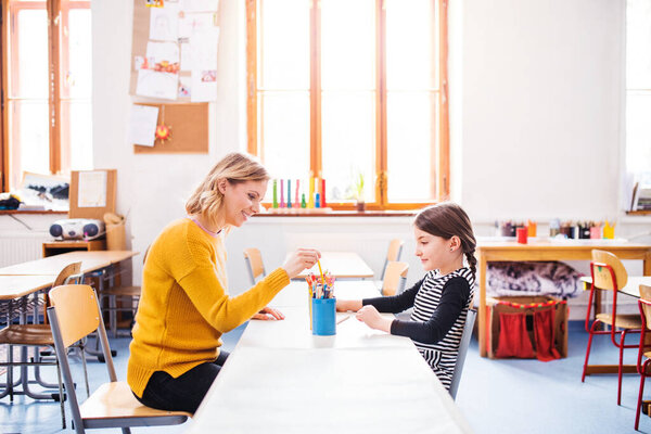 Hardworking Teacher Learning Young Schoolgirl Classroom Sitting Desk One One Royalty Free Stock Photos