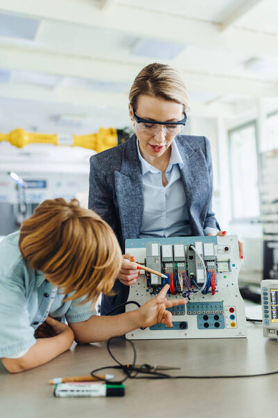 Female Teacher Explaining Circuit Board Schoolboy School Robotics Club Children Royalty Free Stock Photos