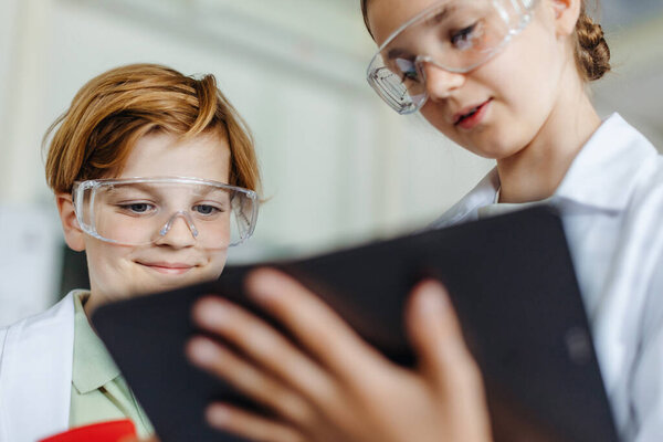 Two Classmates Standing Robotic Laboratory Wearing Lab Coats Safety Eyeglasses Stock Image
