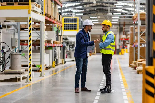 stock image Supervisor, manager scolding employee in modern industry factory. Worker making mistake. Production manger is angry, dissatisfied for workers poor quality work or safety viaolations.