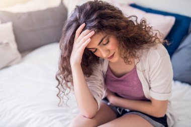 Woman suffering from menstrual pain, having cramps