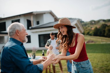 Aileler oğullarını, gelinlerini ve küçük bebeklerini bir barbekü partisinde karşılıyorlar..