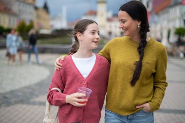 Anne ve kızı kasabada yürüyor, konuşuyor, pazar günlerini birlikte geçiriyorlar..