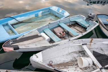Sailing Against Time: Old Boats Fighting to Stay Afloat. Embark on a voyage through time with this captivating photo explores the captivating world of maritime heritage, weathered by years of service, battle against the relentless forces of decay.  clipart