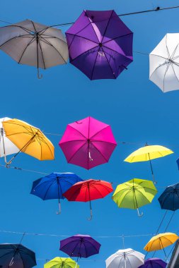 Colorful Umbrellas Hanging Over Street  Vibrant Urban Sky Canopy