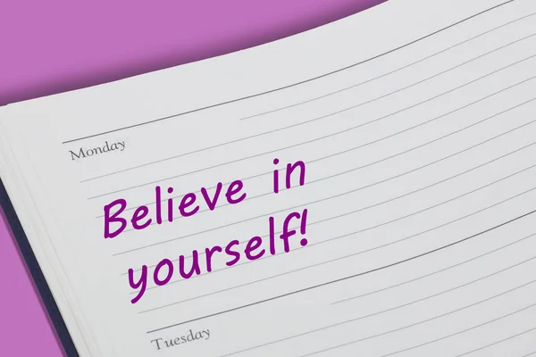 A Believe in yourself diary reminder appointment open on desk