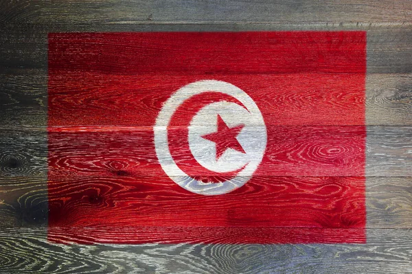 素朴な古い木の表面の背景にチュニジアの旗 — ストック写真