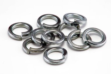 A heap of large split spring washers on white background clipart