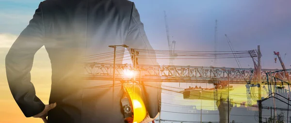 stock image a man in suit holding helmet Industrial and construction design concepts