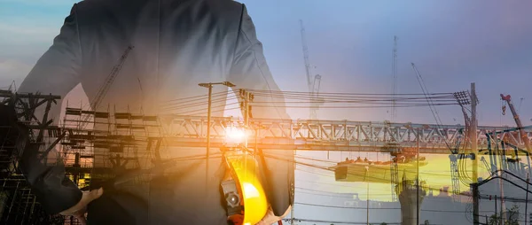 stock image a man in suit holding helmet Industrial and construction design concepts