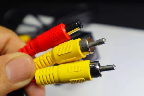 A man holds a TV Audio Video Cable Connector