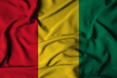 Sallanan kumaş dokusuyla Gine bayrağının seçici odak noktası. 3d illüstrasyon