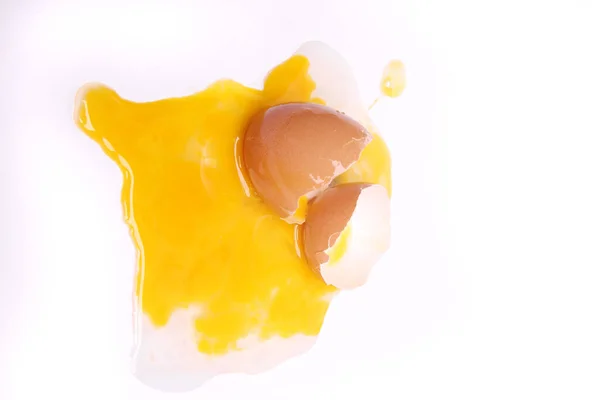 selective focus, half cracked egg and yolk isolated on a white background with clipping path.
