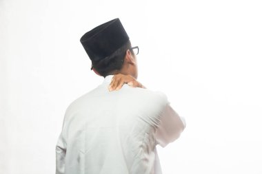 Asyalı Müslüman adam omuzlarını tutuyor, sırtını kameraya dayamış bir portre, stüdyo beyaz üzerine izole edilmiş.