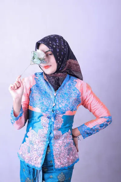 closeup of Asian Indonesian hijab woman blushing with jasmine flowers, isolated on white background