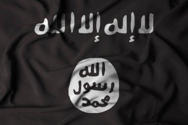 Irak İslam Devleti ve tekstil kumaş arka planında dalgalanan Levant bayrağı. Bayrak sallamanın bir göstergesi. seçici odak