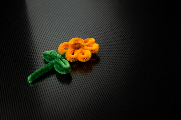 Beautiful Handmade Orange Pipe Cleaner Flower Craft Single, Sunflower Craft Keychain, Isolated Black Background