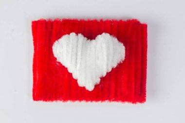 Craft pipe cleaners forming a red square in the middle forming a white love isolated on a white background clipart