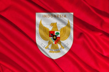 Pringsewu, lamba; 28 Mayıs 2025; Endonezya milli futbol takımının logosu ile bayrağın dokusu dalgalanıyor. 3B illüstrasyon