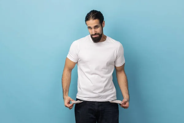Portrait Man Beard Wearing White Shirt Showing Empty Pockets Looking — Stock Photo, Image