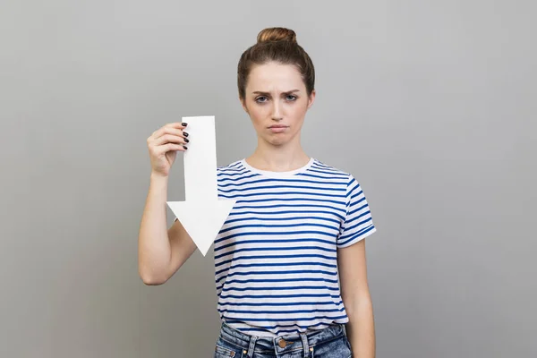 Portrait Sad Upset Woman Wearing Striped Shirt Showing White Arrow — Stock Photo, Image