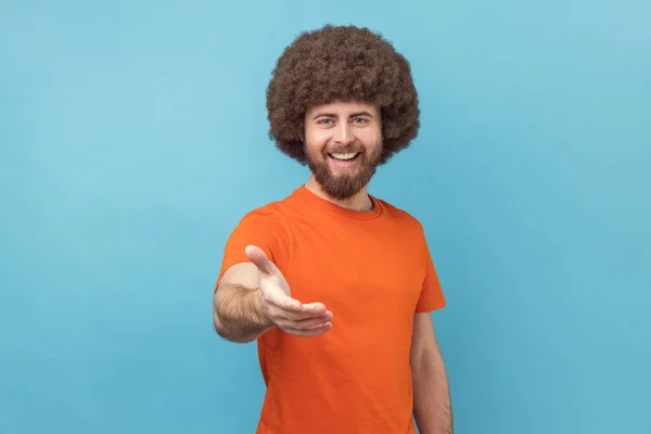 Portrait Man Afro Hairstyle Wearing Orange Shirt Standing Outstretched Hand — Stock Photo, Image