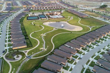 Drone top view of streets with lots houses and green lawn in the summertime outdoor.