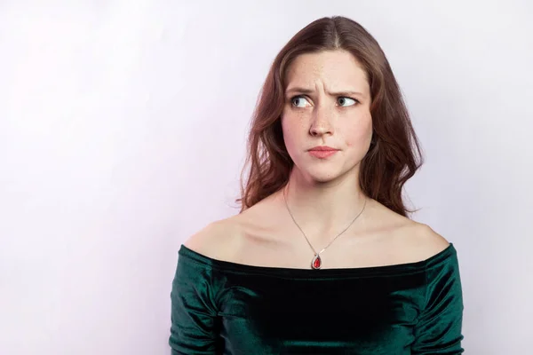Porträtt Förvirrad Förbryllad Pensiv Kvinna Bär Grön Klänning Tittar Bort — Stockfoto