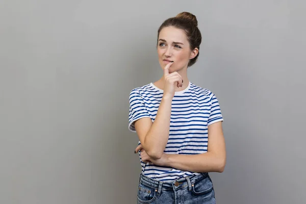 Portrait Woman Wearing Striped Shirt Pondering Serious Issues Looking Uncertain — Stok fotoğraf