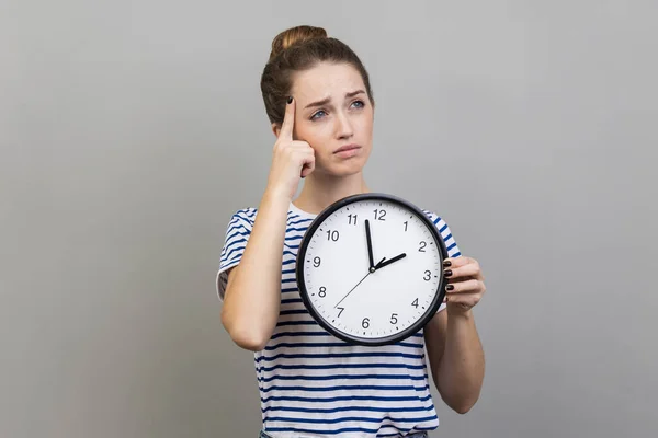 Portrait Pensive Thoughtful Woman Wearing Striped Shirt Holding Wall Clock — Stock Photo, Image