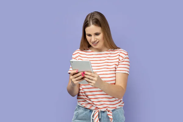 Portrait Smiling Positive Woman Wearing Striped Shirt Holding Working Tablet — Stock Photo, Image