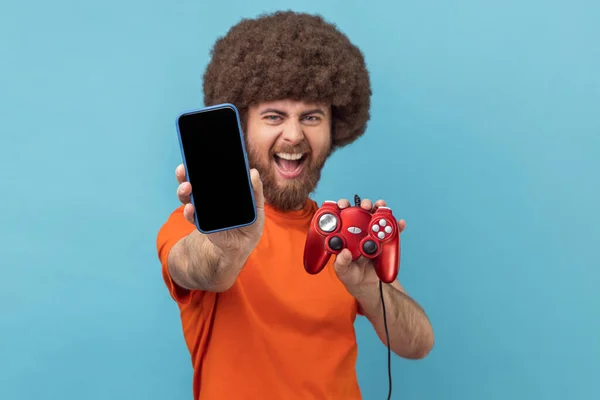 Portrait Excited Man Afro Hairstyle Wearing Orange Shirt Holding Out — Stock Photo, Image