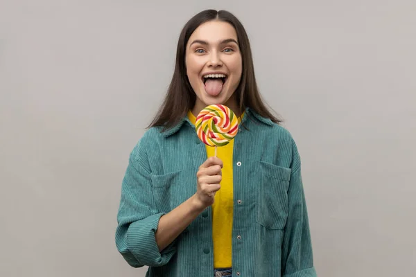 Childish Attractive Woman Licking Multicolor Candy Wants Eat Looking Camera — Stock Photo, Image