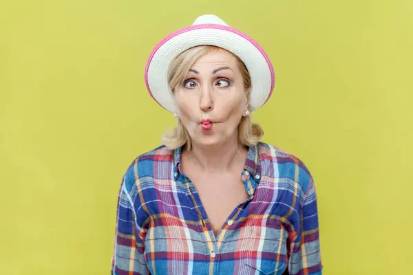 Portrait Mature Woman Wearing Checkered Shirt Hat Puckers Lips Makes — Stock Photo, Image