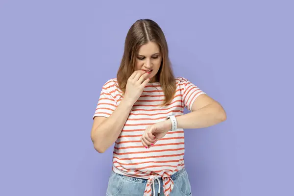Portrait Nervous Blond Woman Wearing Striped Shirt Standing Looking Smartwatch — Stock Photo, Image