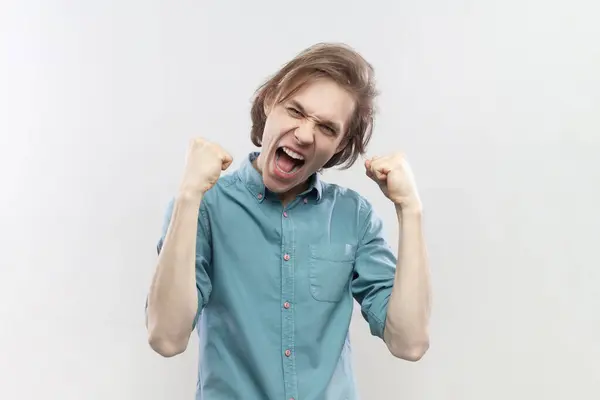Portrait Overjoyed Cheerful Young Man Expressing Winning Gesture Raised Fists — Stock Photo, Image