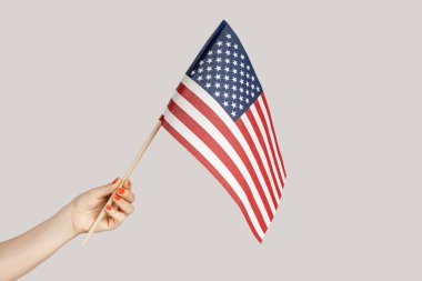 Amerikan bayrağı gösteren kadın resmi, Amerika Birleşik Devletleri 'ne seyahat, göçmenlik. Gri arka planda izole edilmiş kapalı stüdyo görüntüleri.