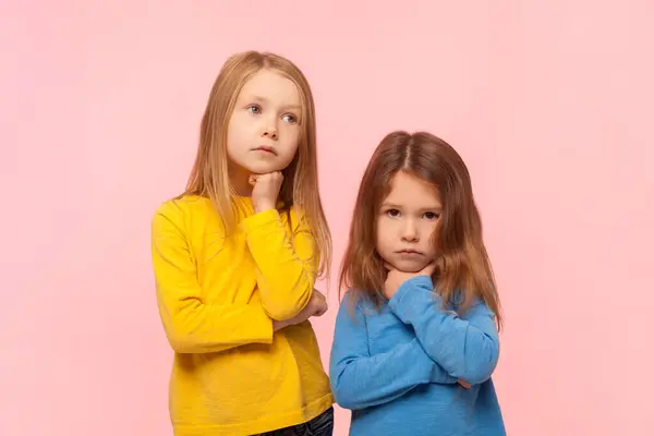 Portrait Two Pensive Cute Little Girls Standing Holding Chin Thinking — Stock Photo, Image
