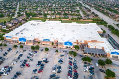 Frisco, TX, USA - July 28, 2024: Aerial view of Walmart Supercenter shopping center with parking spot close by neighborhood. clipart